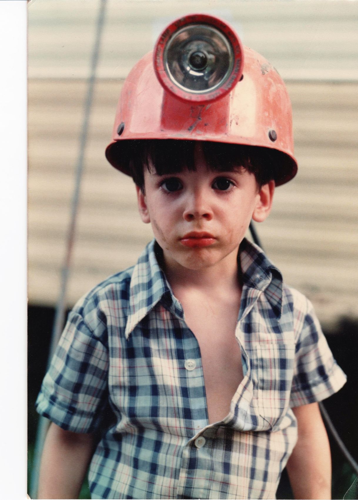 Business Challenge-14 Steven Harris as a child wearing coal miner's helmet with l